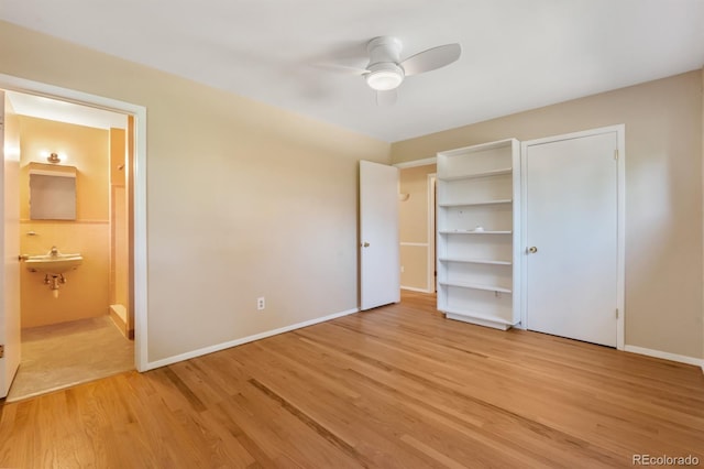 2698 S Niagara St, Denver, CO 80224 - unfurnished bedroom featuring light wood-style flooring, ensuite bathroom, and a ceiling fan