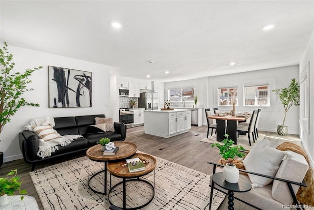 1858 S Lincoln St, Denver, CO 80210 - living area with recessed lighting, light wood-type flooring, and baseboards