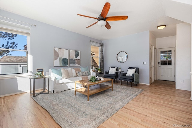 living room featuring light wood-type flooring and ceiling fan