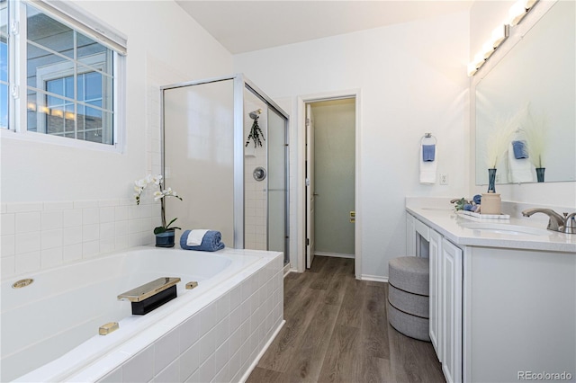 bathroom featuring vanity, plus walk in shower, and hardwood / wood-style flooring