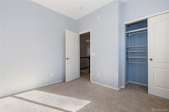 unfurnished bedroom featuring a closet and carpet floors