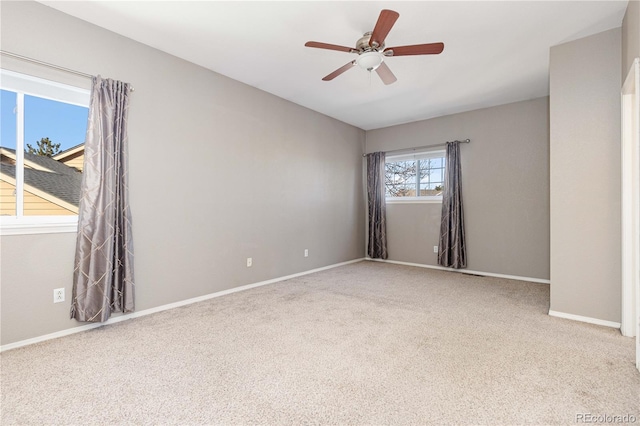 carpeted spare room with ceiling fan