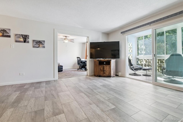 795 S Alton Way Unit 4C, Denver, CO 80247 - living area with a textured ceiling, light wood-type flooring, ceiling fan, baseboards, and a baseboard heating unit