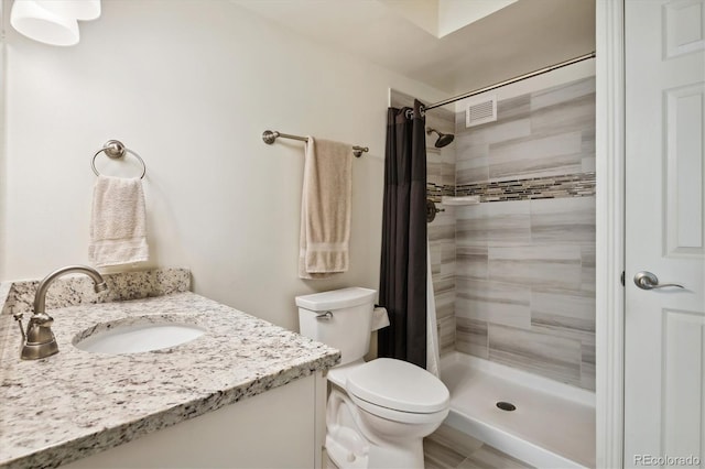 795 S Alton Way Unit 4C, Denver, CO 80247 - bathroom with toilet, a tile shower, and vanity