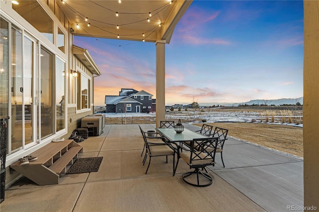 snow covered patio featuring a mountain view