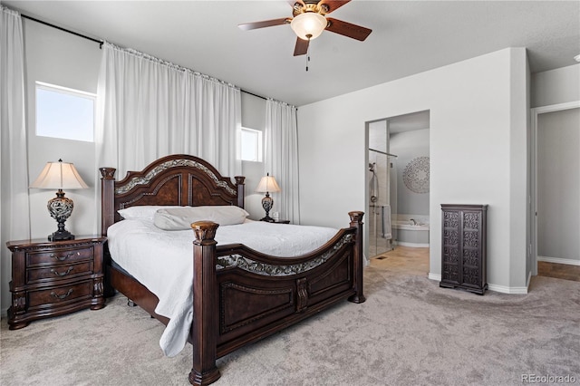 bedroom with light carpet, connected bathroom, and ceiling fan