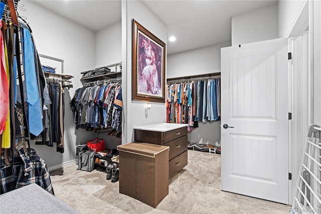 walk in closet featuring light colored carpet