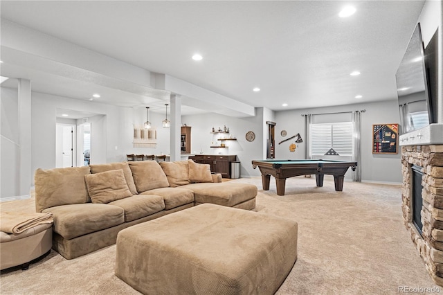 rec room with pool table, indoor bar, a stone fireplace, and light carpet