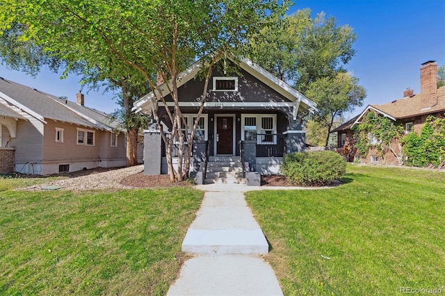 bungalow-style home with a front lawn and a porch