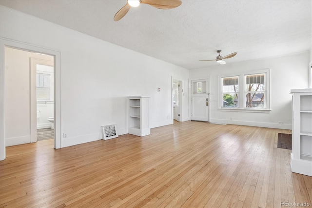 unfurnished living room with ceiling fan, a textured ceiling, and light hardwood / wood-style flooring