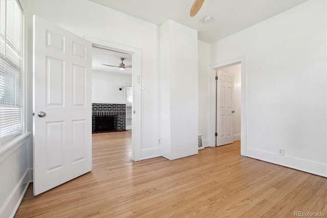 empty room featuring ceiling fan and light hardwood / wood-style floors