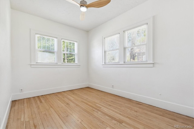 empty room featuring light hardwood / wood-style flooring, ceiling fan, and a healthy amount of sunlight