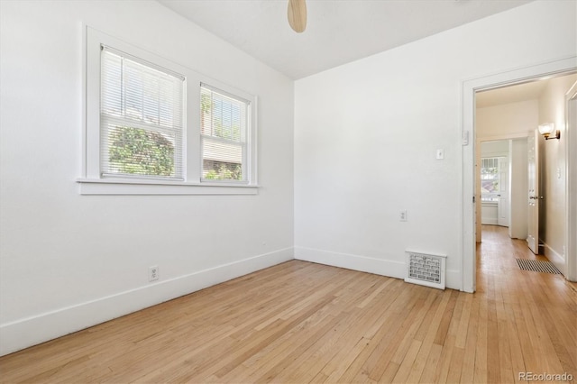 unfurnished room featuring light hardwood / wood-style floors, ceiling fan, and plenty of natural light