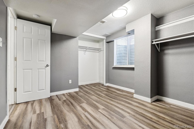 spacious closet featuring light hardwood / wood-style flooring