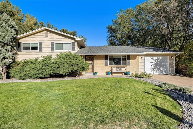 split level home featuring driveway, brick siding, a front lawn, and an attached garage