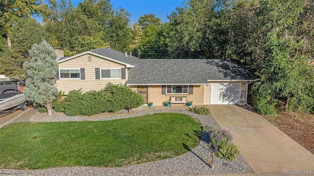 tri-level home featuring a garage, concrete driveway, a chimney, a front lawn, and brick siding