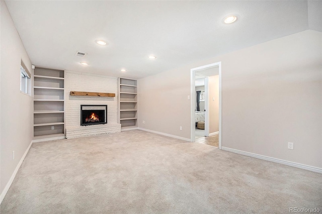 unfurnished living room featuring light carpet, a brick fireplace, baseboards, and visible vents