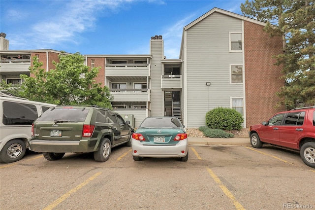 14214 E 1st Dr Unit B08, Aurora, CO 80011 - view of property featuring uncovered parking