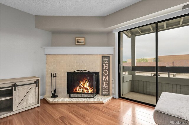 14214 E 1st Dr Unit B08, Aurora, CO 80011 - unfurnished living room featuring wood finished floors and a fireplace