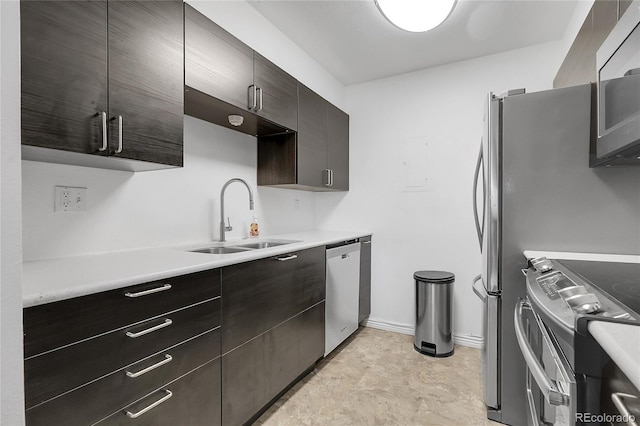 14214 E 1st Dr Unit B08, Aurora, CO 80011 - kitchen featuring stainless steel appliances, light countertops, dark brown cabinetry, and modern cabinets