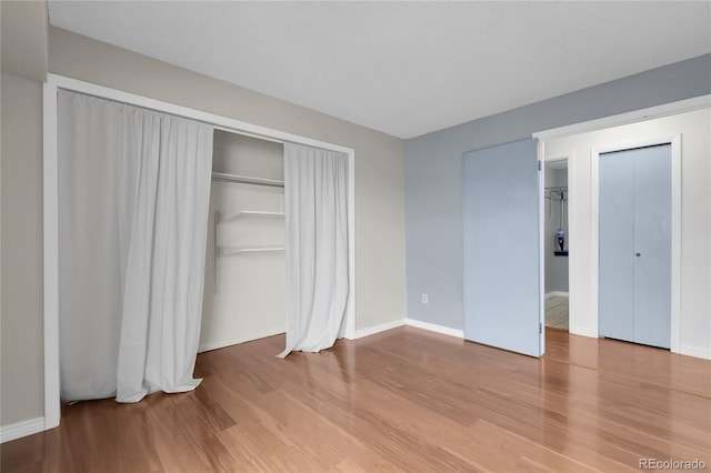 14214 E 1st Dr Unit B08, Aurora, CO 80011 - unfurnished bedroom with wood finished floors and a closet