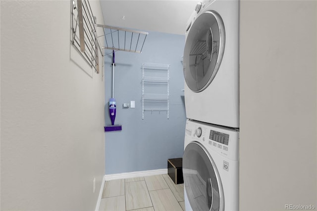 14214 E 1st Dr Unit B08, Aurora, CO 80011 - laundry room featuring stacked washer and clothes dryer and baseboards