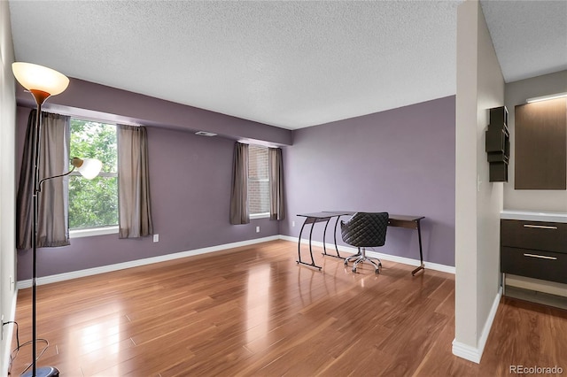 14214 E 1st Dr Unit B08, Aurora, CO 80011 - spare room with wood finished floors and a textured ceiling