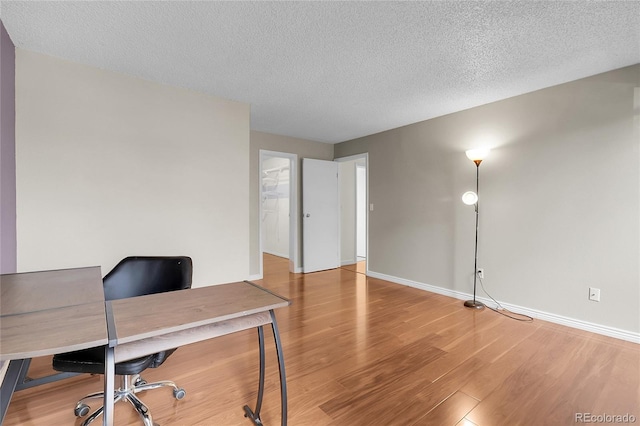 14214 E 1st Dr Unit B08, Aurora, CO 80011 - office area with light wood-style floors and a textured ceiling
