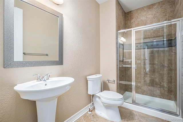 bathroom featuring tile patterned flooring, an enclosed shower, and toilet