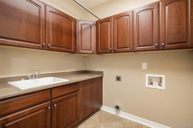 clothes washing area with cabinets, hookup for a washing machine, electric dryer hookup, sink, and light tile patterned floors