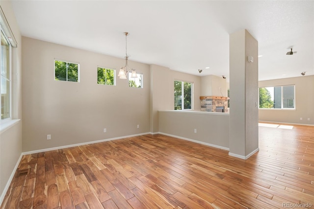 5894 Graphite St, Timnath, CO 80547 - unfurnished room with light wood finished floors and a chandelier