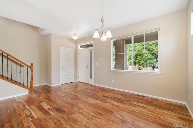 5894 Graphite St, Timnath, CO 80547 - empty room featuring a chandelier, wood finished floors, and stairs