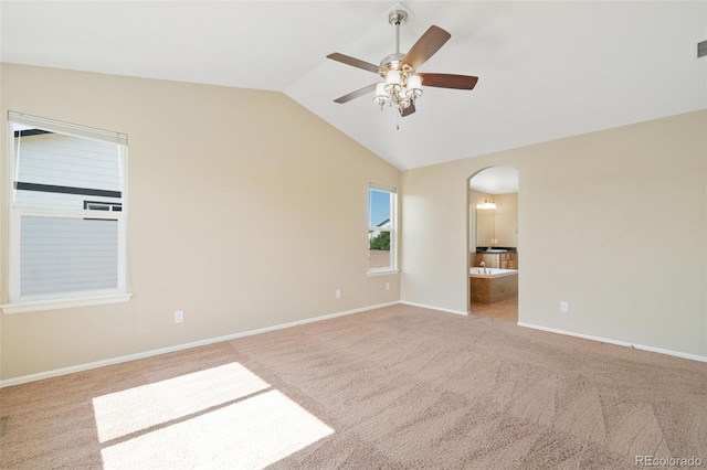 5894 Graphite St, Timnath, CO 80547 - spare room with carpet floors, vaulted ceiling, arched walkways, and a ceiling fan