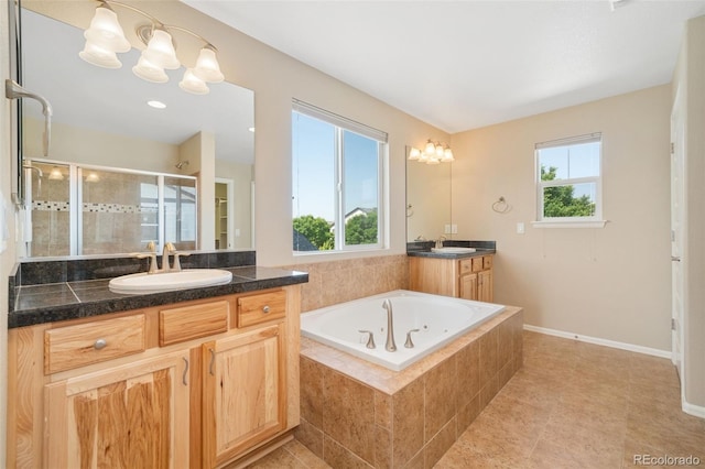 5894 Graphite St, Timnath, CO 80547 - full bath with a stall shower, two vanities, healthy amount of natural light, and a bath