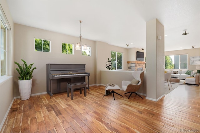 5894 Graphite St, Timnath, CO 80547 - living area with wood finished floors, healthy amount of natural light, and a chandelier