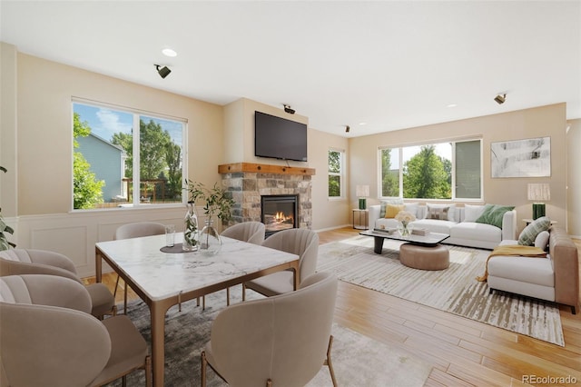 5894 Graphite St, Timnath, CO 80547 - living area featuring healthy amount of natural light, light wood-style floors, a stone fireplace, and recessed lighting