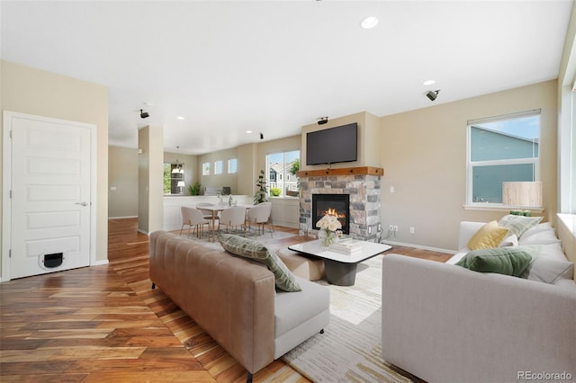 5894 Graphite St, Timnath, CO 80547 - living area with a fireplace, wood finished floors, and recessed lighting