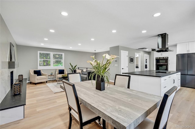 6842 Garland St, Arvada, CO 80004 - dining space with recessed lighting, light wood-style floors, and a fireplace
