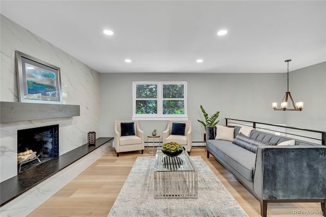 6842 Garland St, Arvada, CO 80004 - living area with a chandelier, a high end fireplace, recessed lighting, a baseboard heating unit, and baseboard heating