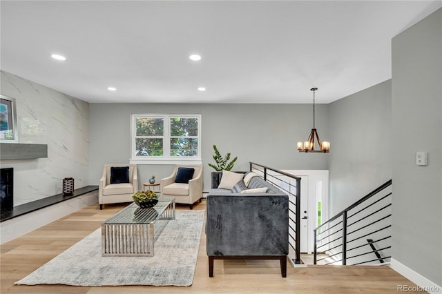 6842 Garland St, Arvada, CO 80004 - living area featuring a chandelier, recessed lighting, a premium fireplace, and wood finished floors