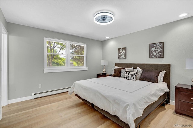 6842 Garland St, Arvada, CO 80004 - bedroom with a baseboard radiator and light wood-type flooring