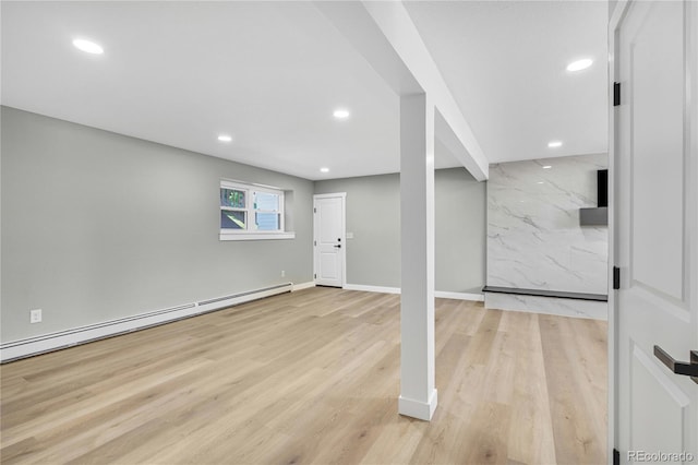 6842 Garland St, Arvada, CO 80004 - below grade area featuring a baseboard radiator, recessed lighting, and wood finished floors
