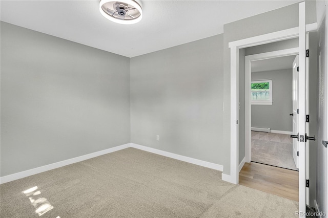 6842 Garland St, Arvada, CO 80004 - empty room with carpet and a baseboard heating unit