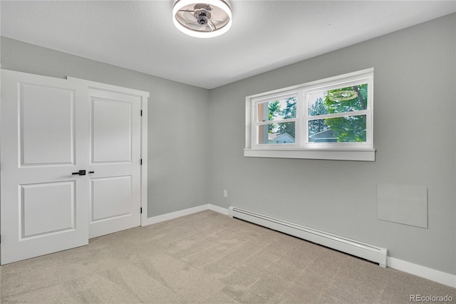 6842 Garland St, Arvada, CO 80004 - unfurnished bedroom with a baseboard radiator and light carpet