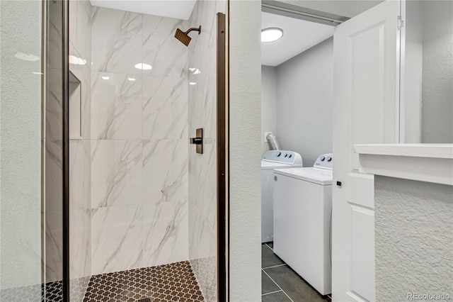 6842 Garland St, Arvada, CO 80004 - laundry area with dark tile patterned floors and washer and dryer