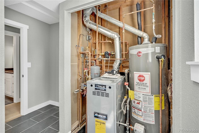 6842 Garland St, Arvada, CO 80004 - utility room featuring gas water heater and a heating unit