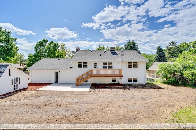 6842 Garland St, Arvada, CO 80004 - back of property featuring a patio area, a wooden deck, stairway, and a chimney
