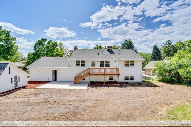 6842 Garland St, Arvada, CO 80004 - back of property featuring a patio area, a wooden deck, stairway, and a chimney