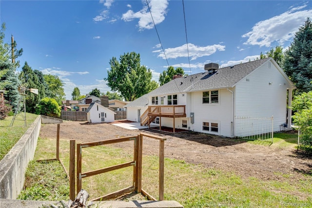 6842 Garland St, Arvada, CO 80004 - back of house featuring a storage unit, a deck, stairs, a chimney, and a shingled roof