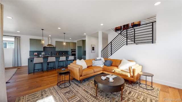 living room with sink and light hardwood / wood-style floors